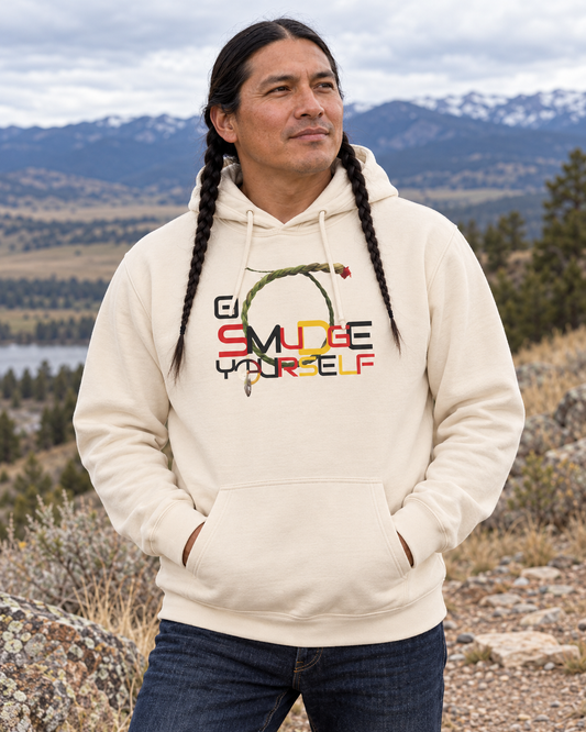 AI-generated lifestyle view of a braided male model wearing the cream Go Smudge YourSelf hoodie in a Montana mountain setting.