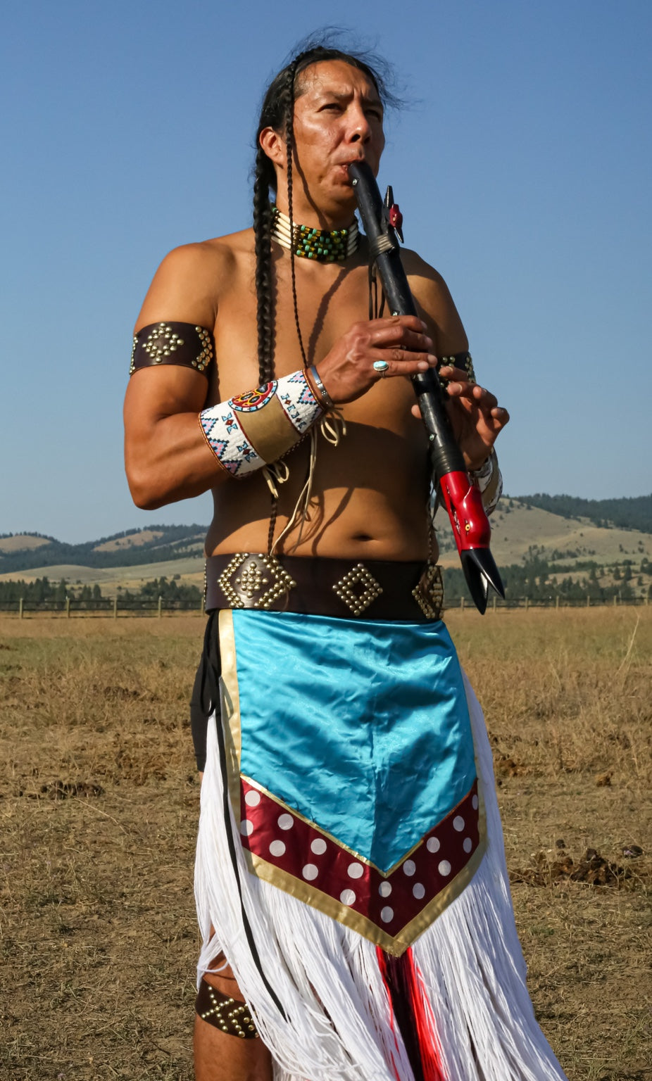 Teague WestWolf GoodVoice playing Native flute outdoors in Montana