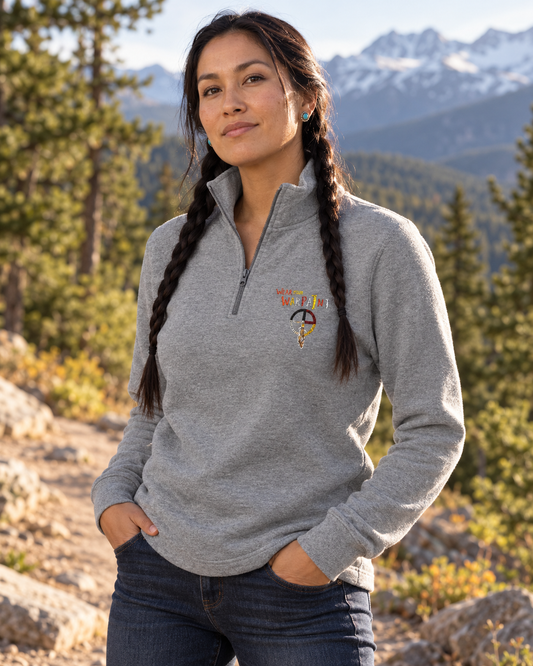 AI-generated lifestyle mockup of the carbon grey embroidered WarPaint half-zip fleece on a braided female model in Montana.
